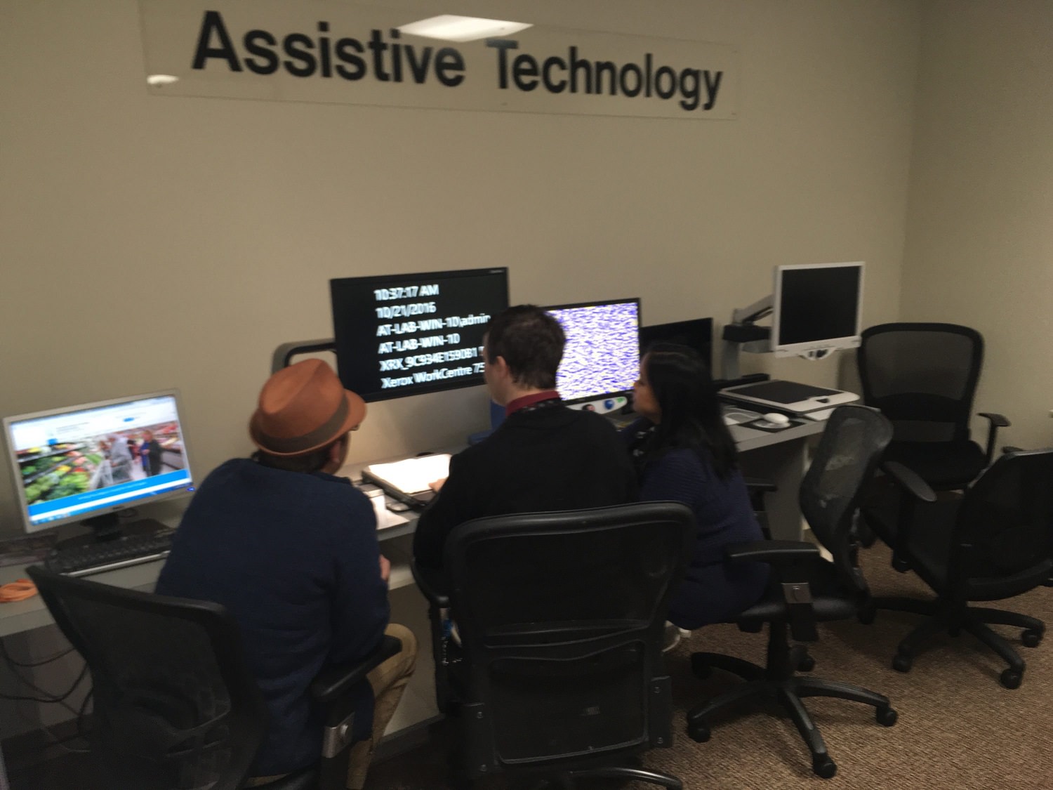 Assistive technology instructor demonstrates a desktop video magnifier. Assistive technology instructor demonstrates a desktop video magnifier.